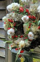 Round birch wreath covered with clematis tangutica and clematis vitalba 

