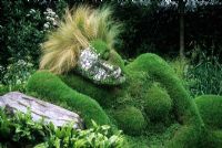 The 4head Garden of Dreams - RHS Chelsea Flower Show 2006 - Living grass sculpture of reclining woman with mirror tiles on half of face and Stipa tenuissima as hair