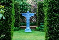 Taxus hedges with view to bronze resin sculpture of St Francis of Assisi by Bill Harling - The Abbey House, Wiltshire 