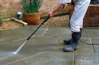 Using pressure washer to clean patio slabs