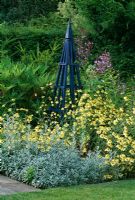 Blue tripod surrounded by Anthemis tinctoria 'E C Buxton' and Artemisia ludoviciana 'Velerie Finnis' - Arrow Cottage, Herefordshire
