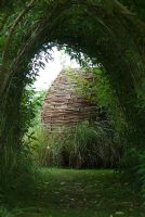 Woven willow urn seen through a Salix - Willow tunnel
