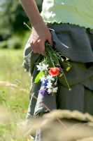 Woman holding bunch of wild flowers