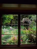 Colourful cottage style garden viewed through window at Keeyla Meadows, San Francisco, California USA