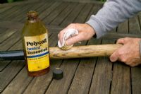 Cleaning and protecting a spade handle with linseed oil
