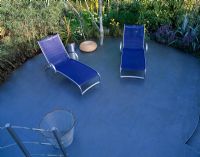 Roof deck with circular blue patio with blue sunloungers in Mercedes Benz garden at Hampton Court 2001.  