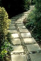 Paving slab path with concrete pavers infilled with pebbles cobbles stones