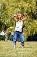 Young girl playing hula hoops