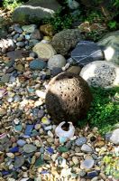 California gravel garden with collection of stones and found objects - Berkeley