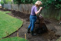 Application of top-soil to newly staked out flower beds