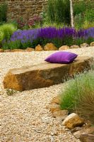 Gravel garden with rock seat, purple cushion and Salvia 'Wesuwe'