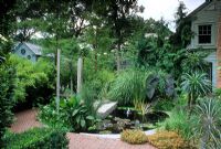 Tropical style suburban front garden at Silas Mountsier's garden in New Jersey, USA