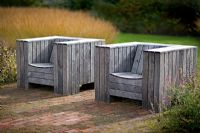Seating in the 'Drifts of grass' garden at The Walled Garden Scampston, North Yorkshire