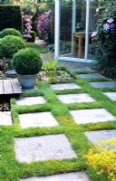Paving slabs and lawn form an unusual patio area