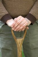Man holding wooden handle