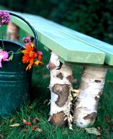 Rustic painted bench with legs made from Birch tree trunks, Maja's garden for children, Sofiero Castle, Sweden