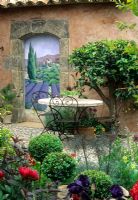 Trompe L Oeil on wall of Mediterranean style garden with scene of lavender fields - Designed by Fiona Lawrenson, RHS Chelsea 1997 