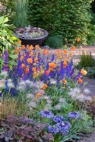 The Bupa Garden designed by Cleve West, RHS Chelsea 2008 with Geum 'Fire Opal', Pulsatilla vulgaris, Scilla peruviana and Hedge of Carpinus betulus - Hornbeam