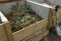 Organic compost in purpose built bay, showing removable retaining boards for access