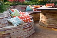 Curved sandstone wall seats and table with hardwood decking - Fleming's and Trailfinder's Australian Garden, RHS Chelsea Flower Show 2008