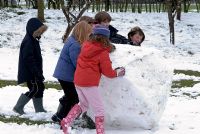 Children making a giant snowball