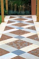 Path with geometric patterns made with brick and stone