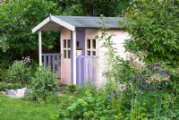 Painted pink and lilac wendy house