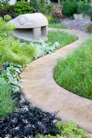 Paths and stone snake in The Marshalls Garden That Kids Really Want!Sponsor Marshalls Gardens and Driveways, Design Ian Dexter, RHS Chelsea Flower Show 2008