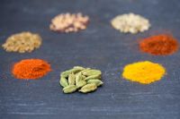 Piles of Indian spice on slate