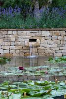 Water feature in wall with Lavandula and Nymphaea - The Dorset Water Lily Garden, RHS Hampton Court Flower Show 2008
