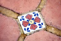 Inset of Moroccan tile in a terracotta patio