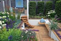 The Sadolin Four seasons Garden showing Sunken deck area with seating and Spiral staircase - RHS Hampton Court Palace Flower Show 2008 - Gold medal
