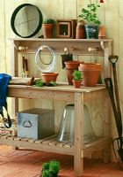 Potting bench with hanging pegs, storage shelf and tray for compost