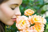 Woman smelling roses