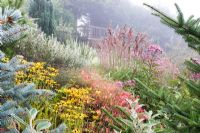 Prairie garden with Rudbeckia deamii and Miscanthus at Honeybrook House Cottage, Worcestershire