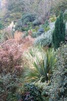 Prairie border with Phormiums, Eupatorium and ornamental grasses at Honeybrook House Cottage, Worcestershire in the Autumn