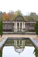 Arbour with reflection in pond in the Italian Garden at Arley Arboretum, Worcestershire, by kind permission of the Trustees of the R D Turner Charitable Trust