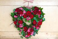Valentine's wreath made from pink and red roses with ivy
