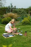 Girl painting in garden