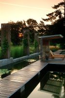 Contemporary garden with ponds and decked areas