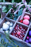 Frosty trug with frosted baubles, cranberries and foliage