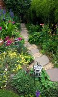 Stepping stones and gravel pathway lined with lanterns and plantings of Gladiolus communis Byzantinus and Aconitum - Cross Villas, Shropshire