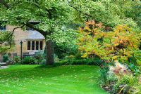 Rhus typhina, Sedum and Stipa tenuissima - East Lambrook Manor Gardens, Somerset