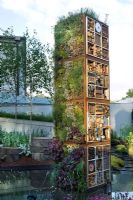 Vertical Garden Tower with mixed planting of edible leaves & herbs, recycled materials for insects to live in. Pond, walls & perennial planting. The Future Nature Garden, Sponsored by Yorkshire Water, University of Sheffield Alumni Fund, Green City Initiative, Buro Happold - RHS Chelsea Flower Show 2009 
