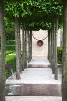 Avenue of Carpinus betulus, Hornbeam with sculpture and water pool - The Laurent-Perrier Garden, Sponsored by Champagne Laurent-Perrier - Gold medal winner at RHS Chelsea Flower Show 2009

