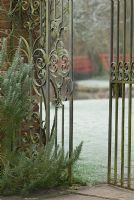 Detail of ornate metal gates in frost, Heale House Gardens, Wiltshire