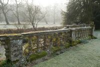 Stone balustrades by the river, Heale House Gardens, Wiltshire in frost