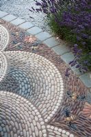Detail of the decorative pebble paving in 'A Beekeeper's Garden' at RHS Hampton Court Flower Show 2009
