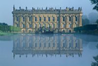 View across the Canal Pond to south facade of house - Chatsworth House, Derbyshire.