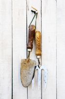 Old metal hand tools hanging on wall